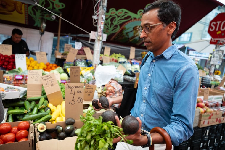 Nikil Saval buying produce in the Italian Market.