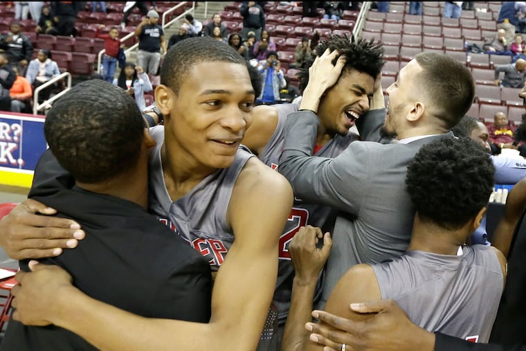 Imhotep's #01 Dahmir Bishop (left) celebrates with teammates at the end of the Imhotep vs Sharon HS Boys Class 4A PIAA State Championship basketball game at the Giant Center in Hershey, Pa. on March 26, 2018. Imhotep won 71-35. ELIZABETH ROBERTSON / Staff Photographer