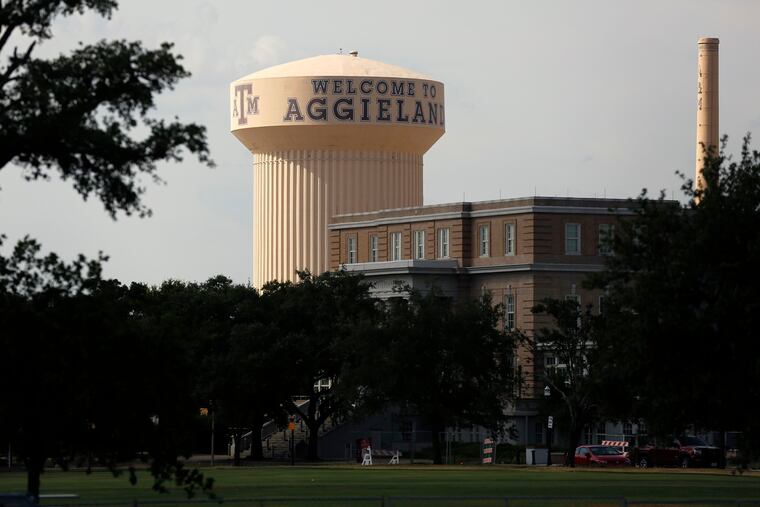 "Welcome to Aggieland" is painted on the central water tower on the Texas A&M University (TAMU) campus in College Station, Texas, Thursday, August 8, 2019.