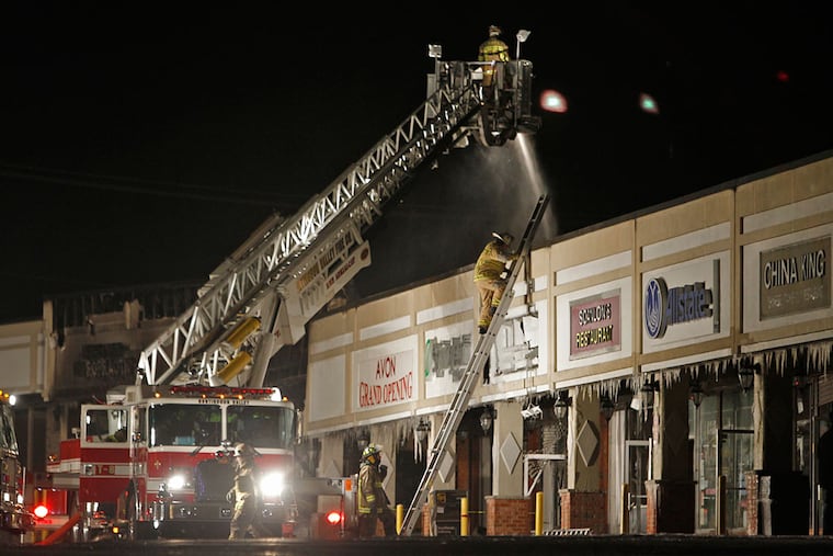 Cheltenham Township Fire Department works at putting out a fire in the Melrose Shopping Center along Cheltenham Ave. on Jan. 25, 2013. The township's Ogontz Volunteer Fire Co. announced in February it will close.