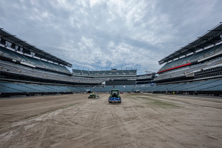 The soccer pitch covering Lincoln Financial Field is dismantled on July 10 as workers begin converting the stadium back to its regular playing surface after hosting FIFA World Cup matches.