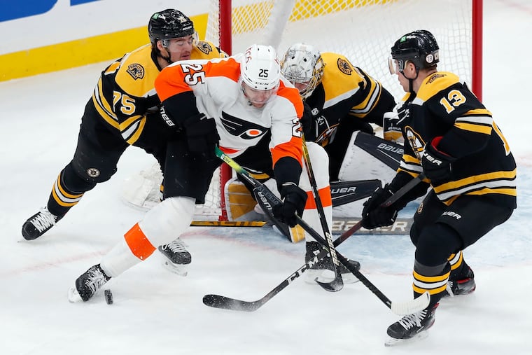 Boston's Connor Clifton (75) and Charlie Coyle (13) defending against the Flyers' James van Riemsdyk (25) during the third period Monday. The Flyers defeated Boston in overtime, 3-2, and inched to within three points of the Bruins.