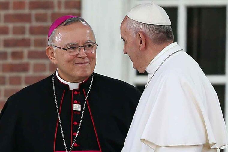 Archbishop Charles Chaput smiles at Pope Francis before he speaks at Independence Hall in Philadelphia on Sept. 26, 2015.
