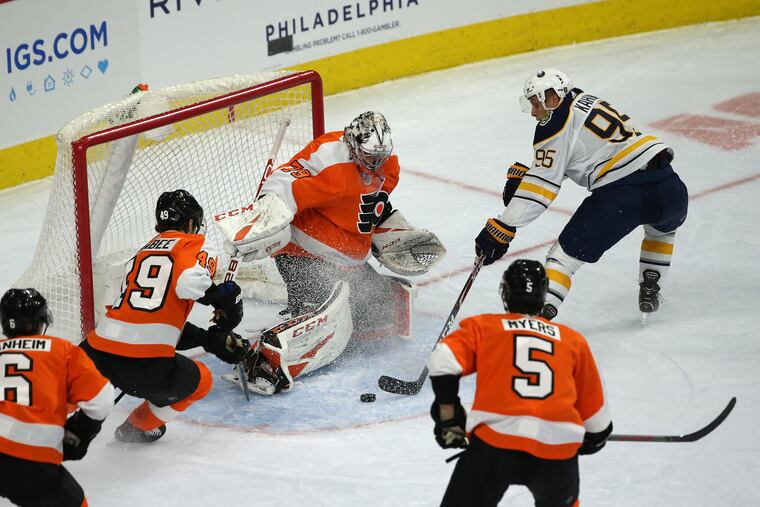 Carter Hart, center, of the Flyers stops a shot by Dominik Kahun, right, of the Sabres during the 2nd period at the Wells Fargo Center on March 7, 2020.
