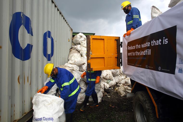 Workers load garbage which was collected from Mount Everest in trucks in Kathmandu, Nepal, Wednesday, June 5, 2019. Officials in Nepal say a government expedition to Mount Everest has removed 11,000 kilograms (24,200 pounds) of garbage and four dead bodies from the world's highest mountain. (AP Photo/Bikram Rai)