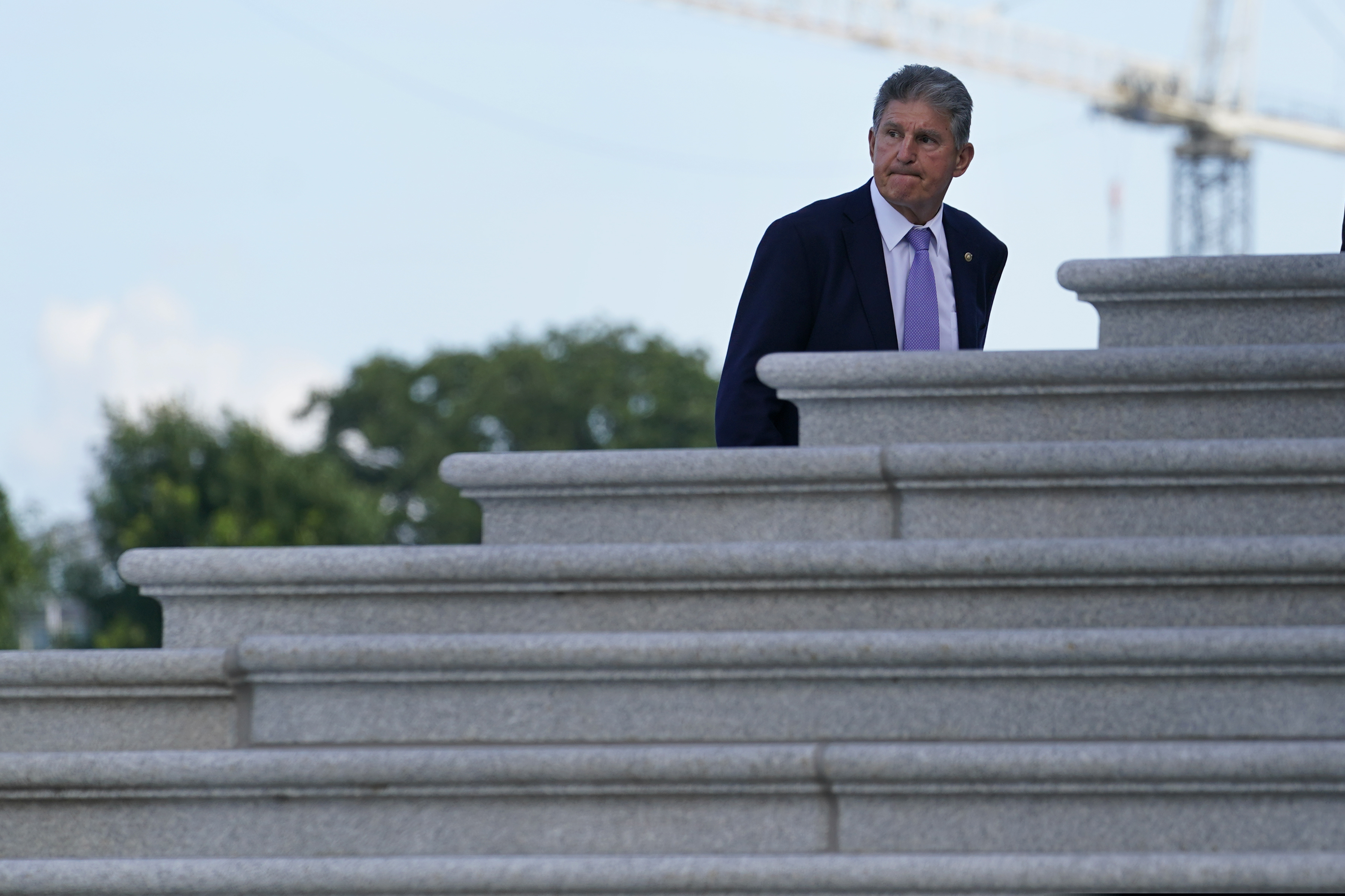Sen. Joe Manchin (D., W.Va.) walks up the steps of Capitol Hill in Washington on Monday.