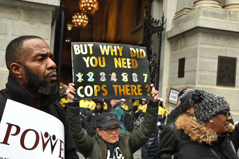 Dani Jo, 31, of Kensington, with Black Lives Matter, holds her sign as she joins protesters organized by the interfaith group POWER outside City Hall April 19, 2018, rallying against the decision of officers to arrest two black men at a Center City Starbucks last week.