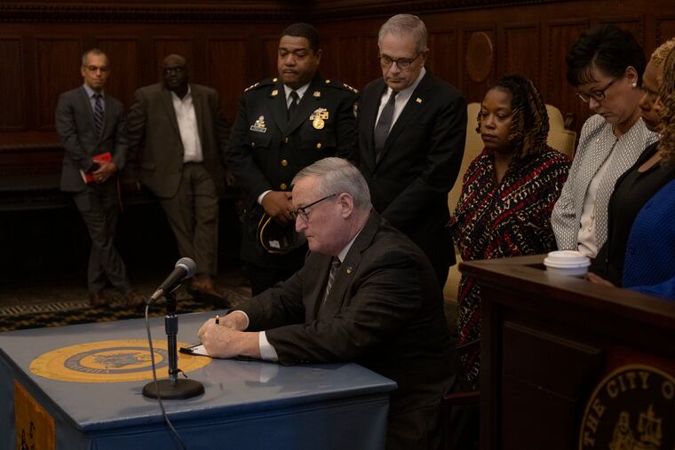 Mayor Jim Kenney signs an executive order on Tuesday banning guns and other deadly weapons from city recreation facilities.