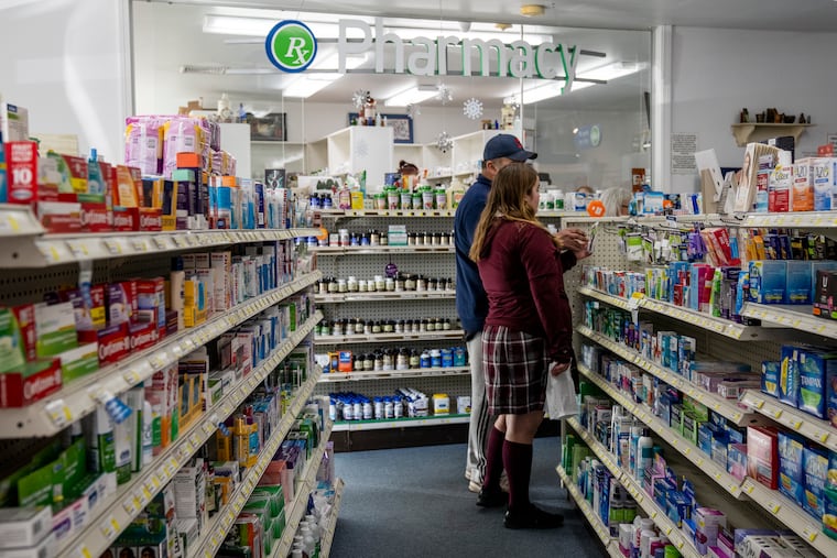 Customers shop as they wait for a prescription at a pharmacy in Killingworth, Conn., in 2021.