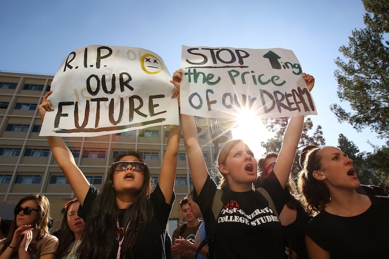 In 2009, University of California Los Angeles students Andrea Flores (left) and Kendall Brown demonstrated outside the UC Board of Regents meeting, where members voted to approve a 32% tuition hike.
