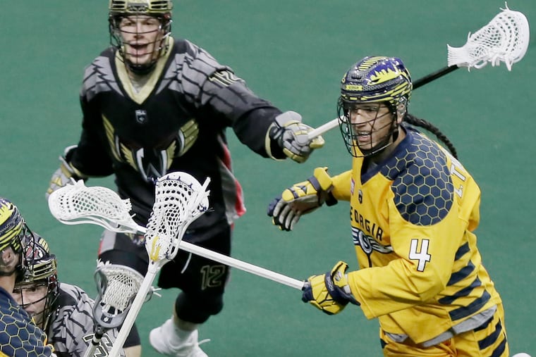 Lyle Thompson (left) is pursued by the Wings' Liam Patten during Philadelphia's loss to Georgia on Saturday.