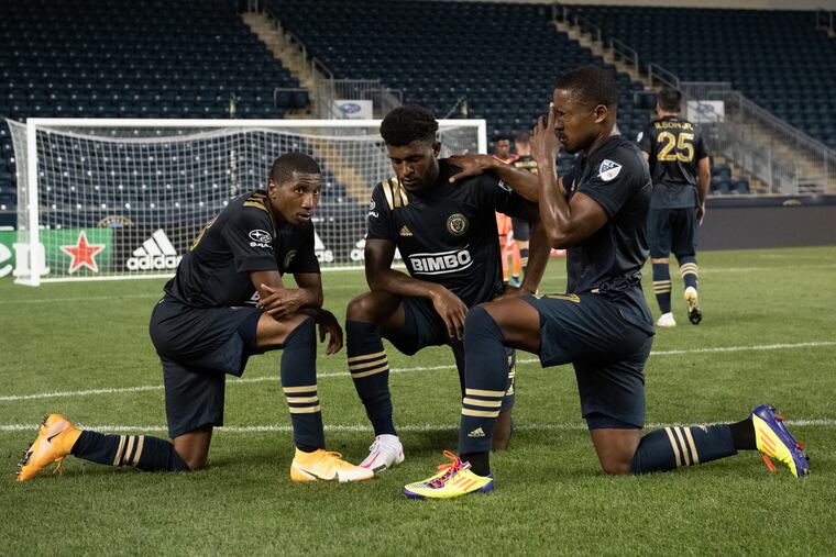 Ray Gaddis (left), Mark McKenzie (center) and Sergio Santos take a moment together after the Union's 1-0 win over the New York Red Bulls on Tuesday.