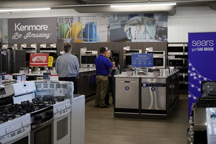 Customers browse appliances at a Sears.