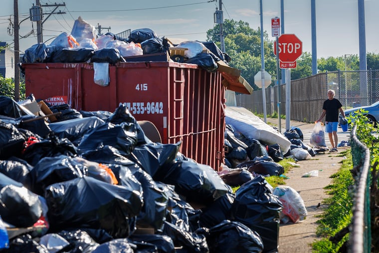 Residents with trash arrive at a garbage dump site at Caldera and Red Lion Roads in Northeast Philadelphia last week.