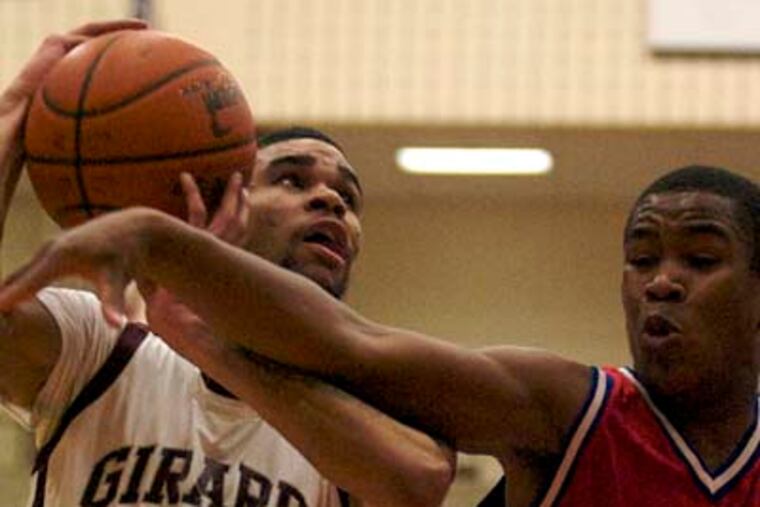 John Johnson of Girard drive to the basket against Tyree Wilson of Scotland School for Veterans Children during the PIAA Class A Boys' Basketball State Semifinals on Tuesday. (John Costello / Staff Photographer)