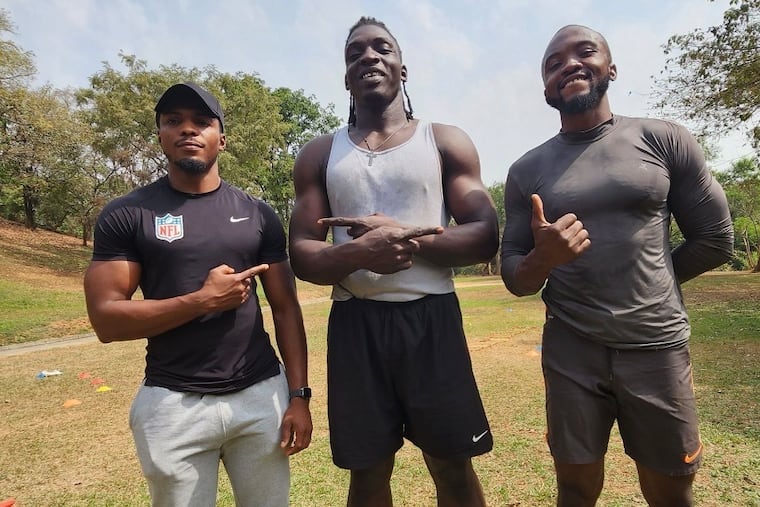 Uar Bernard (center) with his Nigerian football coaches, Dike Christian (left) and Mustapha Musa (right).