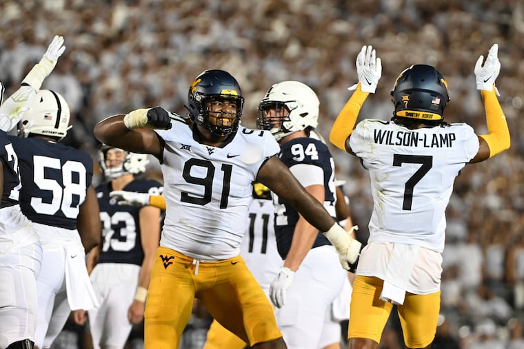 West Virginia defenders Sean Martin (91) and Andrew Wilson-Lamp celebrate after a missed field-goal attempt by Penn State kicker Sander Sahaydak (93) on Saturday.