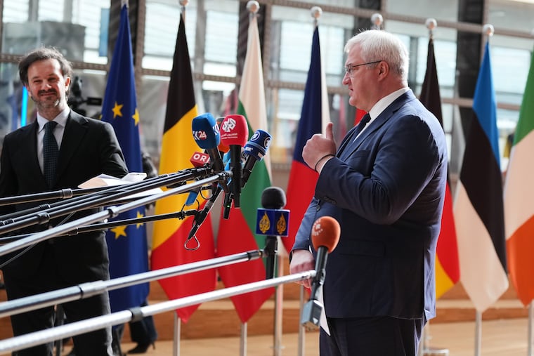 Ukraine's Foreign Minister Andrii Sybiha, right, speaks with the media as he arrives for a meeting of EU foreign ministers at the European Council building in Brussels, Monday, May 11, 2026.