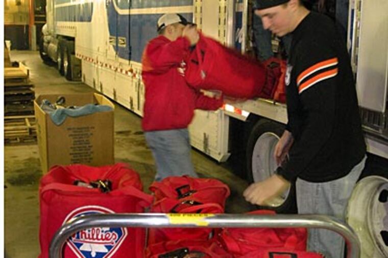 Phillies clubhouse workers load bags full of baseballs into the moving van parked outside the Phillies clubhouse. (Tom Gralish/Staff Photographer)