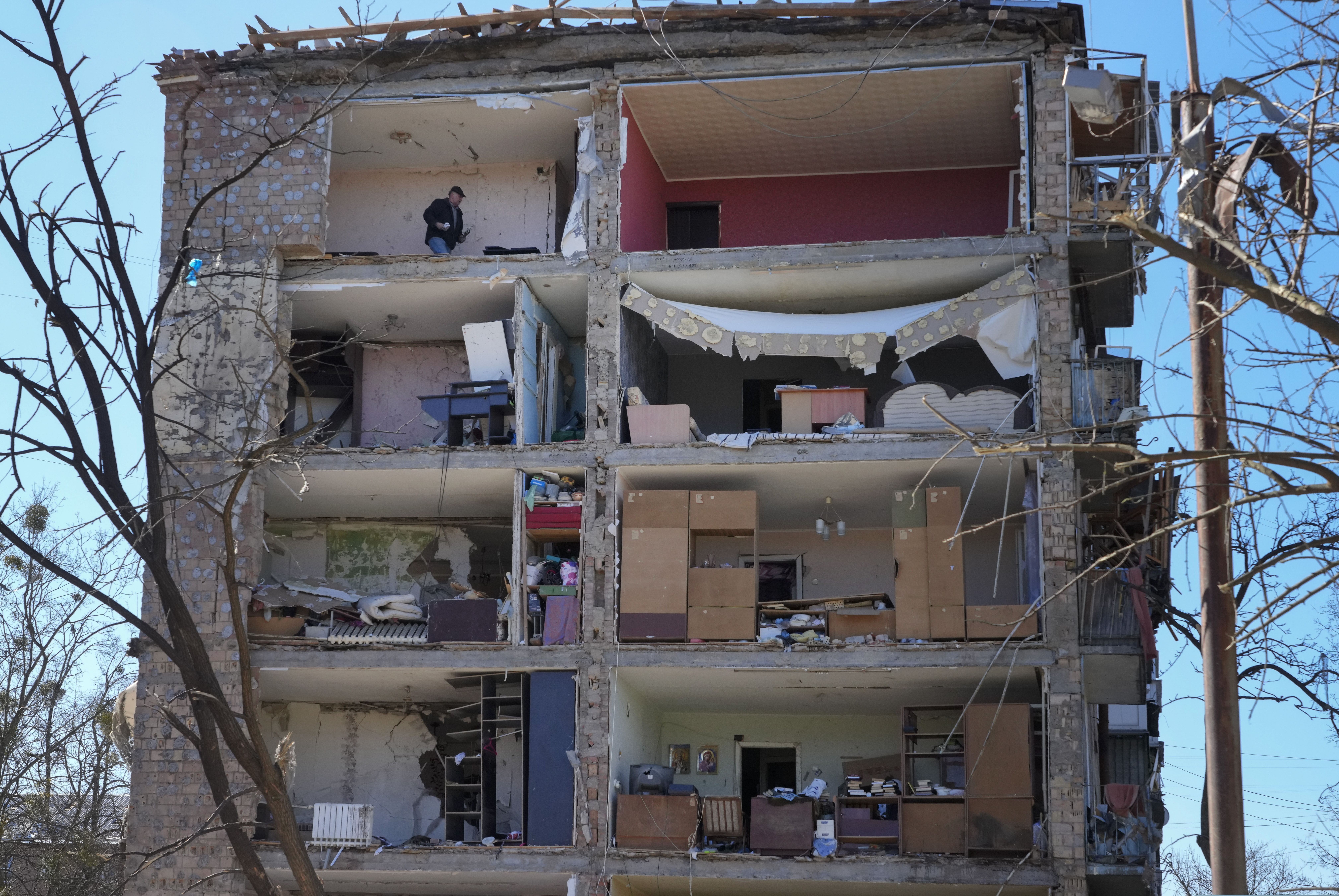 A man walks in his apartment ruined after the Russian shelling in Kyiv, Ukraine, on Monday.
