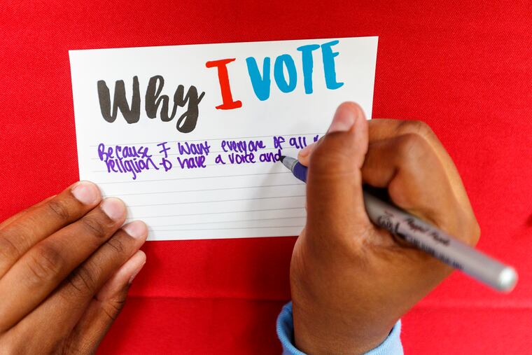A Community College of Philadelphia student fills out a Why I Vote card after registering to vote during a registration drive on Sept. 24, 2019.