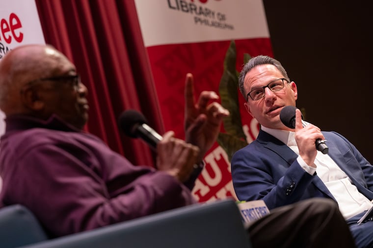 Gov. Josh Shapiro shares the stage with U.S. Rep. James Clyburn at an event at the Free Library of Philadelphia earlier this month. Shapiro will kick off his own book at the Philadelphia's Parkway Central Library in January.