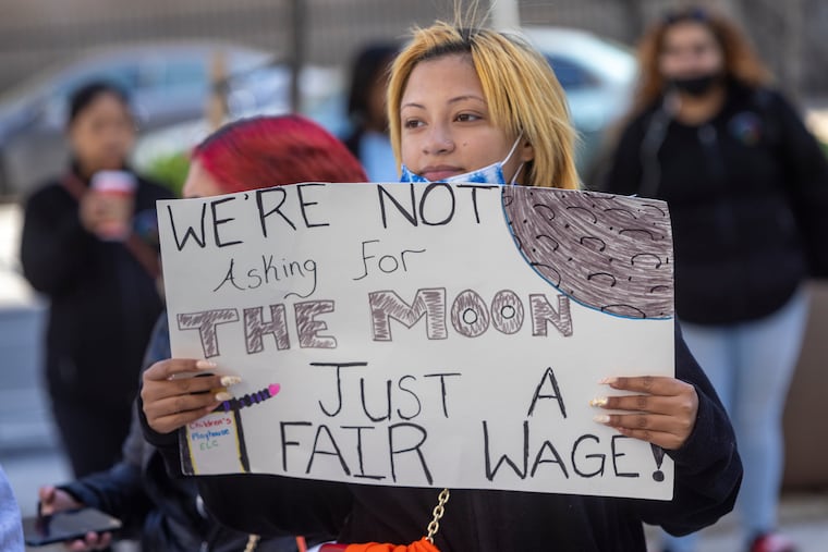 A woman holds a sign during a childcare protest at Philadelphia City Hall in 2022. Philadelphia childcare centers shut down for “Day Without Child Care: National Day of Action" to bring attention to childcare crisis.