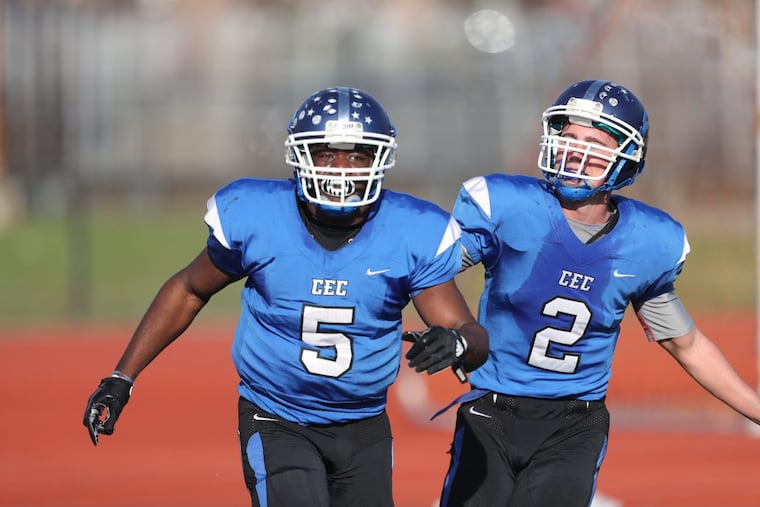 Patrick Garwo (5) and Chuck Layton (2) celebrate one of Garwo’s three touchdowns in last Saturday’s 34-17 victory over Palisades.