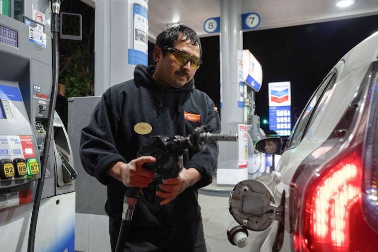 An attendant prepares to fill a customer's tank at a gas station in Portland, Ore., on May 10.