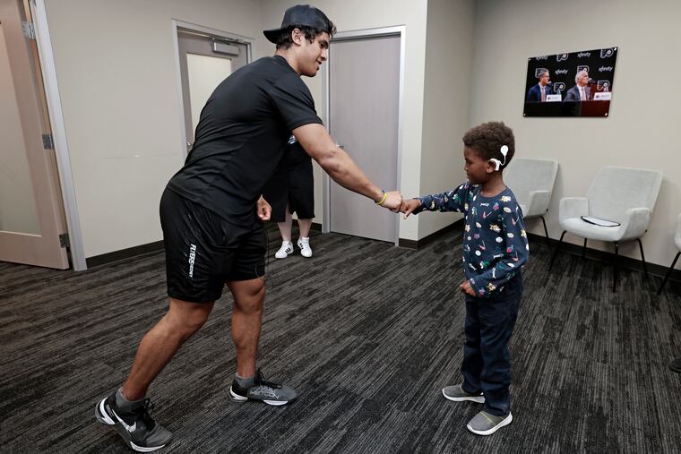 Flyers prospect Noah Powell meets Howard James, 7, before a Flyers development camp scrimmage on Saturday. Both Noah and Howard are hearing impaired.