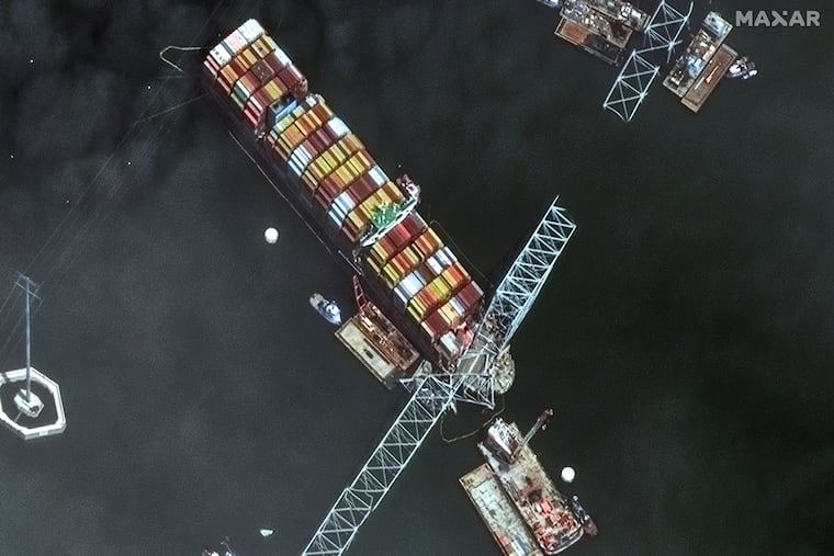 This satellite image provided by Maxar shows the bow of the container ship Dali remains stuck underneath sections of the fallen Francis Scott Key Bridge, while salvage crews and barges with cranes continue removing some of the bridge debris and hundreds of shipping containers still onboard the vessel, in Baltimore, last week.