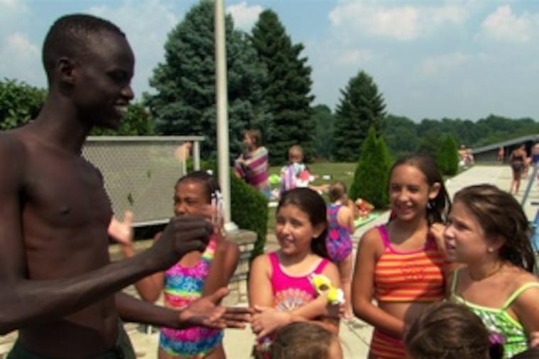 Daniel Abul Pach visits a Pittsburgh pool in the documentary "God Grew Tired of Us." He and two other young Sudanese men must navigate an alien American culture.
