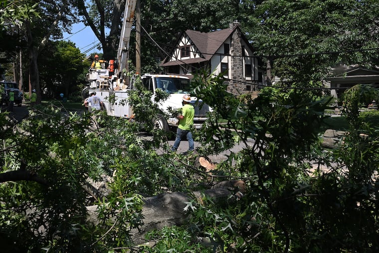 Utility workers restore power on Beacom Lane in Merion Station on Monday.