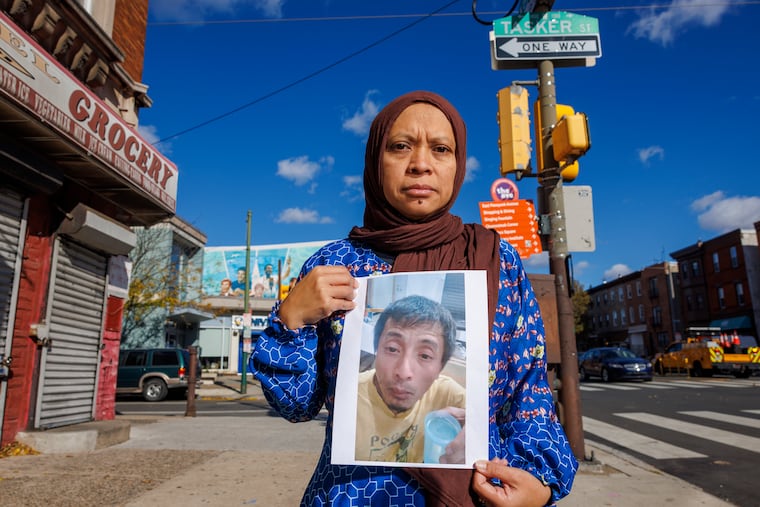 Siti Rahayu of Philadelphia holds a photograph of her husband, Rian Andrianzah. He walked into a United States Citizenship and Immigration Services office for what he thought was a routine appointment but instead was taken into custody. Photograph taken on Thursday, November 6, 2025.