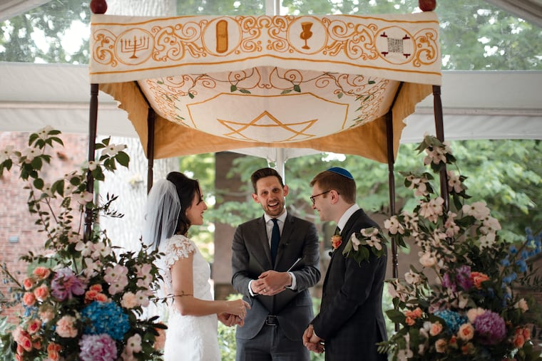 Megan and Jason under the wedding chuppah with Rabbi Nathan Kamesar.