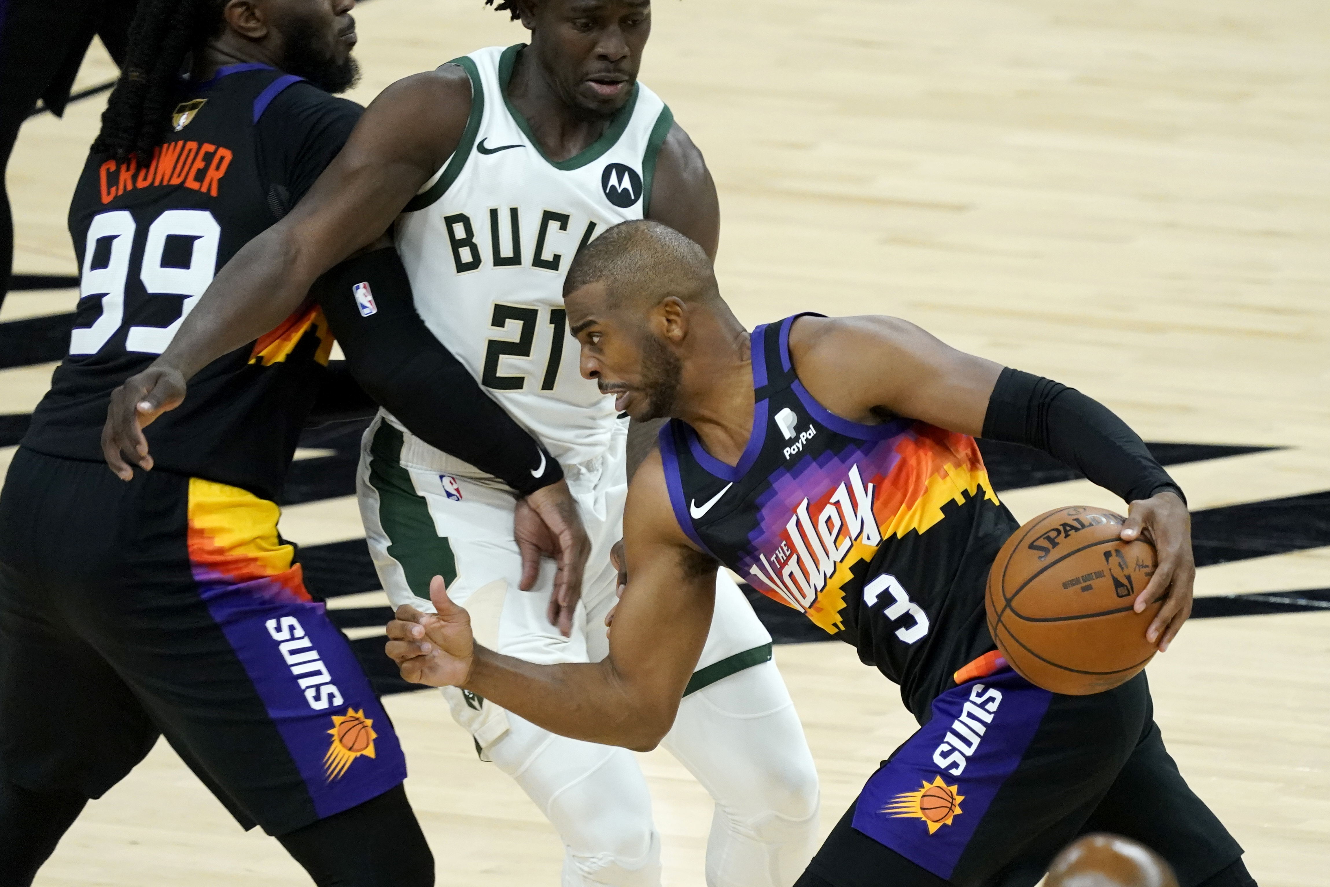 Phoenix Suns guard Chris Paul drives pst Milwaukee Bucks guard Jrue Holiday during the second half of Game 1.