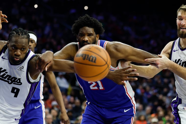 Sixers center Joel Embiid competes with the Kings players for a rebound. His team was beat 46-24 on the boards.