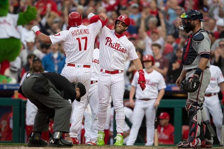 Philadelphia Phillies, Rhys Hoskins, left, is congratulated by Bryce Harper after hitting a grand slam in the 7th inning against the Atlanta Braves at Citizens Bank Park, in Philadelphia, Pa. Thursday, March 28, 2019.