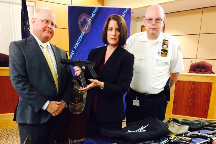 Risa Vetri Ferman, Montgomery County district attorney, shows a Tec-9 semiautomatic pistol taken from one of the defendants.