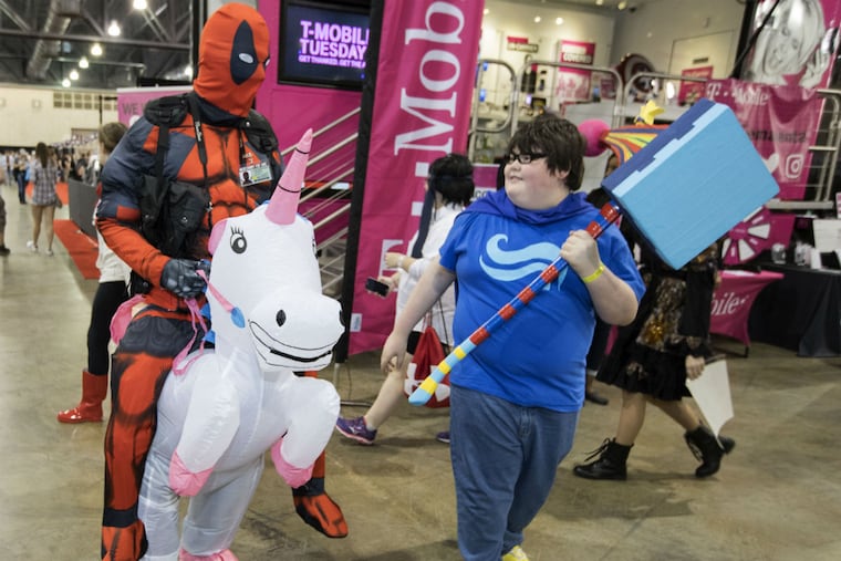 Paul Hogan, left, who was dressed as Deadpool on Buttercup, talk with Stephen Bukowski, who carries the Warhammer of Zillyhoo, at Wizard World Philadelphia at the Pennsylvania Convention Center on June 2, 2017.