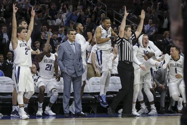 Villanova’s bench celebrates against DePaul as coach Jay Wright watches the action on Feb. 21.