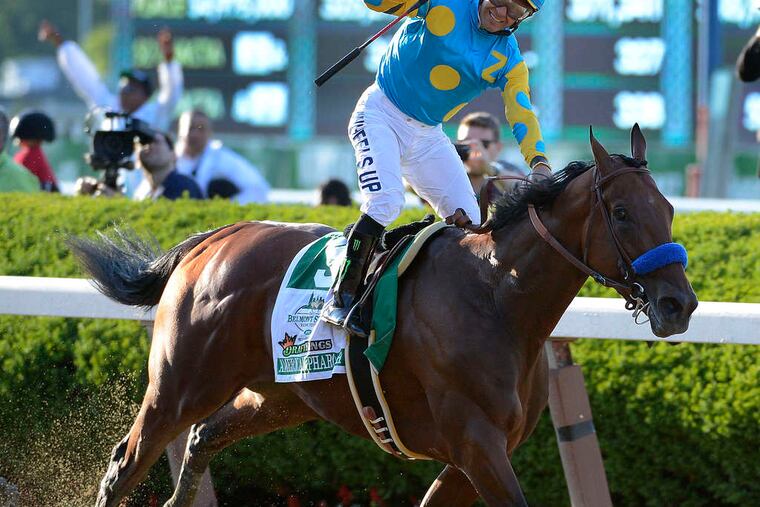 Jockey Victor Espinoza rejoices after winning the Triple Crown with American Pharoah at the Belmont Stakes. BILL KOSTROUN / Associated Press