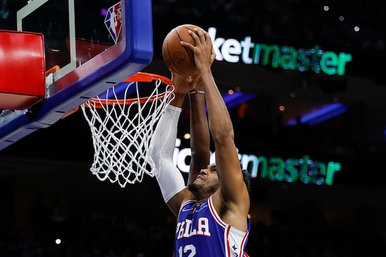 Sixers forward Tobias Harris attempts to dunk the basketball while getting fouled by Atlanta Hawks center Clint Capela in the second quarter on Oct. 30.