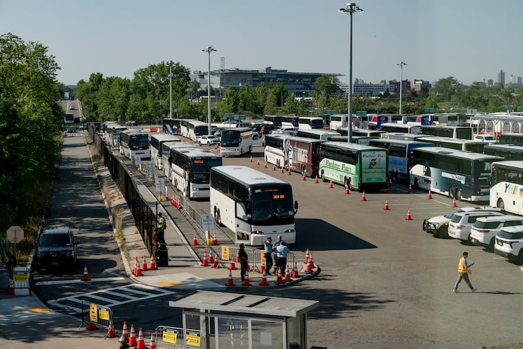 Free buses queued up for afternoon commuters who would normally take the Long Island Rail Road at the Howard Beach/JFK Airport station in New York, on Monday, May 18, 2026. A strike on the LIRR, America’s busiest passenger rail service, was poised to disrupt the evening rush-hour commute on Monday, as negotiating unions and the Metropolitan Transportation Authority remained unable to reach a deal.