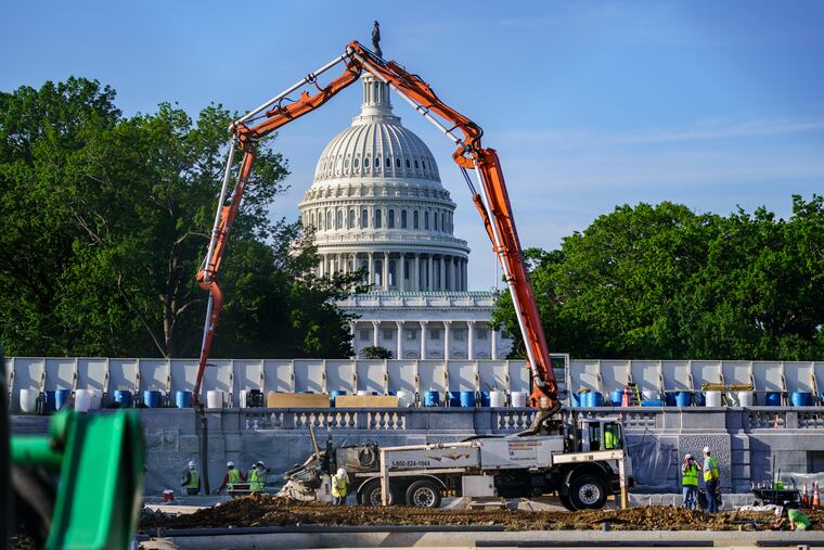 A concrete pump frames the Capitol Dome during renovations and repairs to Lower Senate Park on Capitol Hill in Washington on Tuesday.