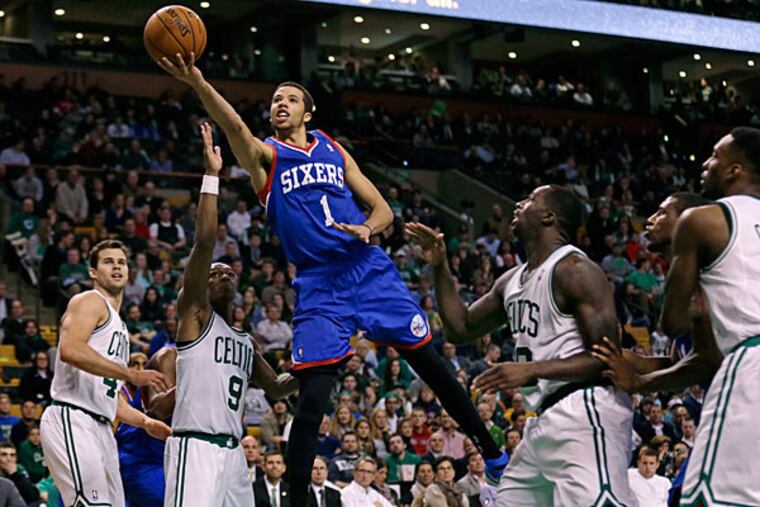 Michael Carter-Williams (1) drives through the Boston Celtics for a basket during the second half of an NBA basketball game Friday, April 4, 2014, in Boston. Carter-Williams had 24 points in the 76ers' 111-102 win. (Charles Krupa/AP)