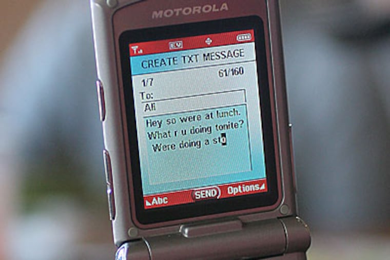 Ashley Becker, a premed student at Bryn Mawr College, text messages a friend during her lunch with classmates at Cosi in BrynMawr. (Michael Bryant / Inquirer)