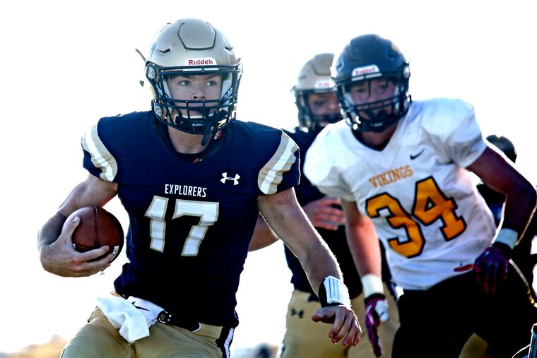 La Salle quarterback Gavin Daly scores on a 16-yard run ahead of Archbishop Wood defender David Armstrong during the fourth quarter.