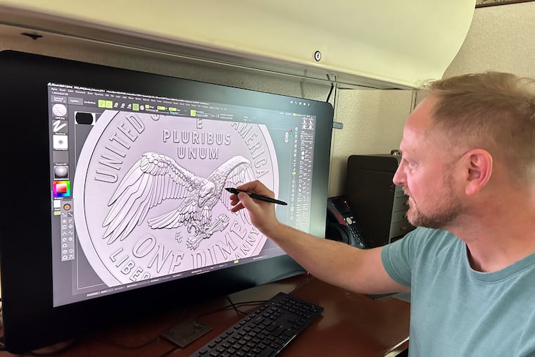 Medallic artist Eric David Custer at his workstation, showing his design for the tails side of the semiquincentennial dime on a computer screen.