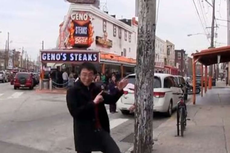 Filmmaker Jerry Liu (above) went out and video'ed his Philly-centered "Happy" tribute, complete with cheesesteaks and dancing locals (below, left). Over at the school district building, worker Chris Hawkins led a crew with some intricate foot- and props-work.